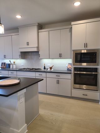 A modern kitchen with sleek cabinets, stainless steel appliances, and under-cabinet lighting.