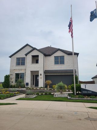 Elegant white brick home with manicured landscaping in Windmore by Trophy Signature Homes (Princeton, TX).