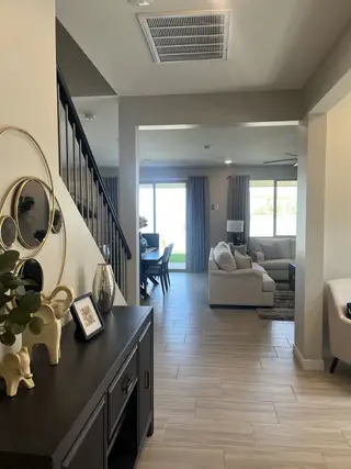 A modern open living space with elegant decor, seamless transition from dining to lounge, and stylish accents.