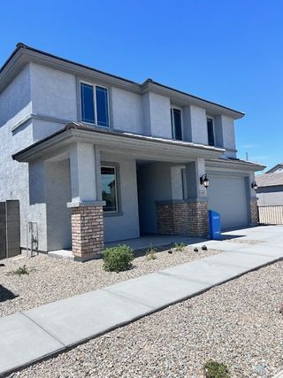 A modern two-story home with a brick-accented porch in Bentridge – Canyon Series by Landsea Homes (Buckeye, AZ).