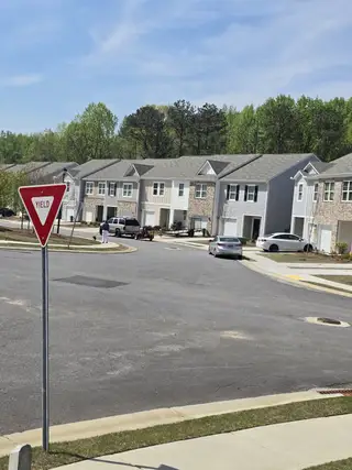 Street view A charming suburban street with modern townhouses in Aviary Park by Starlight Homes, Atlanta, GA.