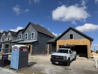 Street view A modern home under construction in South Brook by David Weekley Homes, Leander, TX.