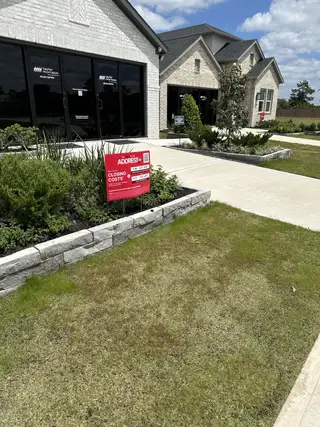 Street view A charming brick home with landscaped frontage in Raburn Reserve 50s by Taylor Morrison, Tomball, TX.