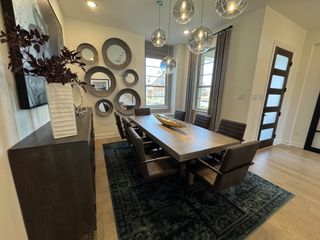 A modern dining room featuring circular wall mirrors, a sleek table, and pendant lighting for a chic and inviting space.