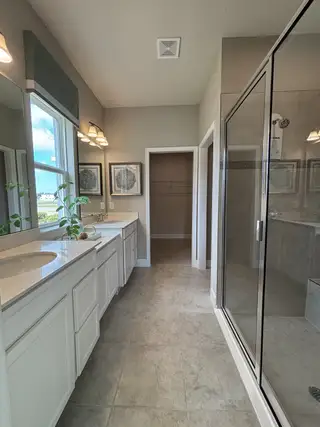 A modern, open-concept home with a spacious and elegant design. The home features a seamless flow between the kitchen, dining, and living areas, creating a bright and airy atmosphere. 