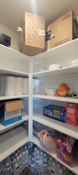Model Home A well-organized pantry with ample shelving, stocked with essentials and snacks, providing convenience and functionality.