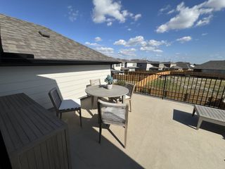 A stylish balcony with a modern outdoor dining setup, ideal for entertaining.