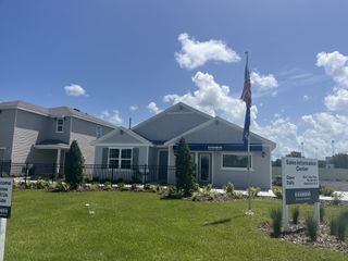 A charming sales center with manicured landscaping in Avalon Woods by D.R. Horton (Newberry, FL).