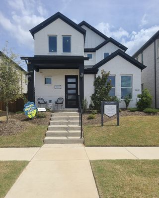 Street view A modern white brick home with black accents in Symmetry 37s by Landon Homes, Frisco, TX.