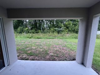 A tranquil backyard patio overlooking lush greenery, offering serene views and privacy.