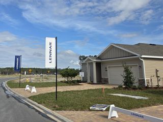 Street view A charming single-story home with a tidy lawn and welcoming facade in Trailmark by Lennar, St. Augustine, FL.