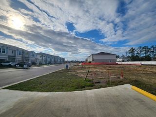 Newly developed suburban homes under a vast sky in The Landing by D.R. Horton (Middleburg, FL).