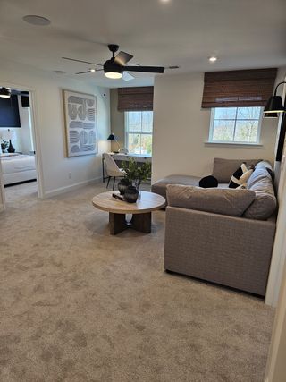 A cozy family room featuring a plush sectional, stylish art, desk nook, and neutral tones with modern accents.