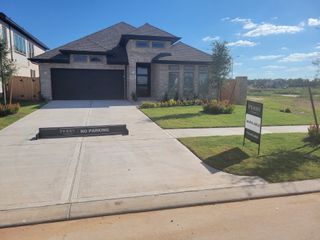 Street view A modern brick home with sleek design in Fulbrook on Fulshear Creek 60' by Perry Homes (Fulshear, TX).