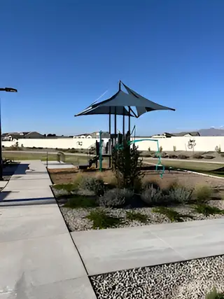 A scenic playground with modern equipment and landscaping in Grove at Lehi by Blandford Homes (Mesa, AZ).