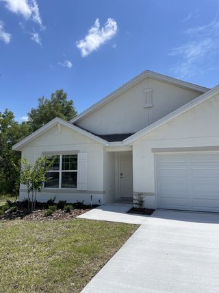 Street view A charming white home with a sleek facade in Citrus County Spot Lots by D.R. Horton (Citrus Springs, FL).