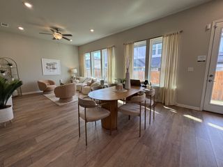 Open-concept living features a bright dining area flowing into a cozy living space, perfect for modern living.