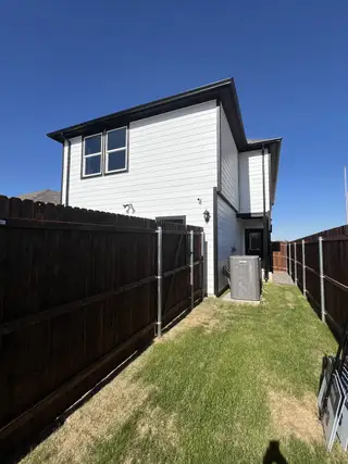 Street view A charming two-story home with a fenced yard in Orchard Village by D.R. Horton (Fort Worth, TX).