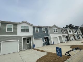 Modern townhomes with varied siding in Dawson Branch by Starlight Homes, creating a welcoming vibe in Summerville, SC.