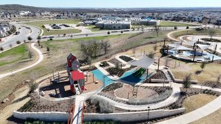 Model Home A vibrant community park with trails, playground, and shaded areas in Easton Park 50s by Taylor Morrison (Austin, TX).