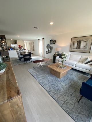 A modern living area with cozy seating, elegant decor, and a spacious dining area, perfect for gatherings and relaxation.