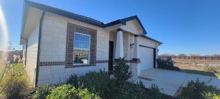 Street view Charming stone home with manicured landscaping in Mesa Vista by CastleRock Communities (Von Ormy, TX).