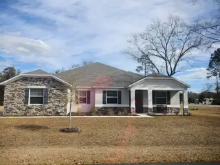 A charming stone-accented home with manicured lawn in Fox Meadows by Maronda Homes (Middleburg, FL).