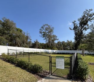 Community Amenities Fenced dog park oasis offering open green space for pets to play in Oak Pointe by D.R. Horton (Apopka, FL).