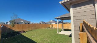 A lovely backyard with a wooden fence and patio in Mesa Vista by Century Communities (Von Ormy, TX).