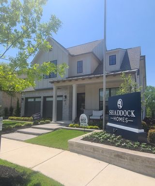A stunning modern home with a landscaped yard in Aster Park by Shaddock Homes (McKinney, TX).