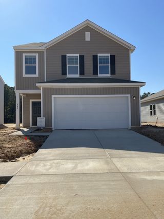 A modern two-story home with a clean facade and garage in Pender Woods at Cane Bay by Starlight Homes (Summerville, SC).