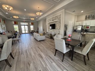 A beautifully designed clubhouse with modern furnishings and elegant lighting in Kindred by D.R. Horton (Kissimmee, FL).

