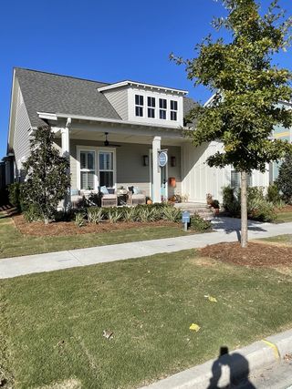 A charming craftsman-style home with lush landscaping in Nexton by Homes by Dickerson (Summerville, SC).