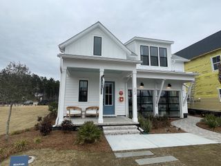A charming white home with a welcoming porch in Nexton - Midtown by DRB Homes (Summerville, SC).
