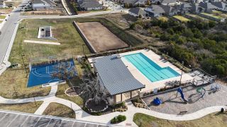 Aerial view of Crescent Bluff by Pulte Homes in Georgetown, TX, highlighting community amenities, open landscapes, and nearby homes.