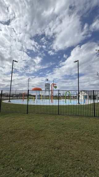 Community Amenities A vibrant splash pad with playful water features in Santa Rita Ranch: 60ft. lots by Highland Homes (Liberty Hill, TX).