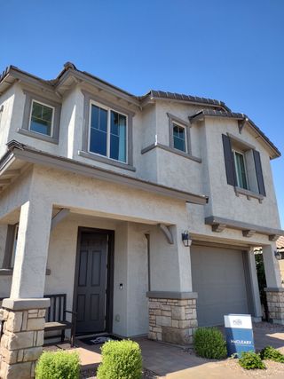 A modern two-story home with stone accents in Allen Ranches by Pulte Homes, Litchfield Park, AZ.