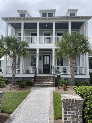 A charming Southern-style home with inviting porches and lush landscaping in Riverside at Carolina Park by Homes by Dickerson (Mount Pleasant, SC).