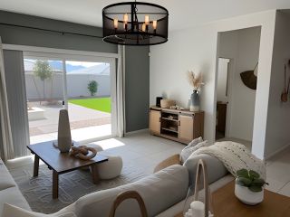 A cozy living room featuring neutral decor, a sleek coffee table, and a large sliding glass door to the patio.