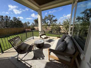 Street view A cozy patio with modern seating and a scenic backyard view, perfect for relaxation.