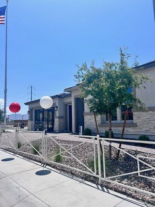 A sleek contemporary home with modern accents and a landscaped front yard in Estates at Laveen Vistas by Richmond American Homes (Laveen, AZ).
