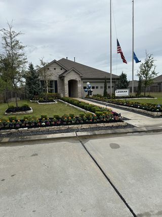 Street view A charming brick home with manicured gardens in Ladera Creek by Lennar (Conroe, TX).