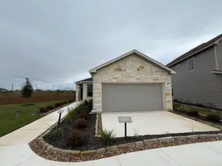 Beautiful stone exterior and landscaped yard, perfect for outdoor living in Davis Ranch by Pulte Homes (San Antonio, TX).
