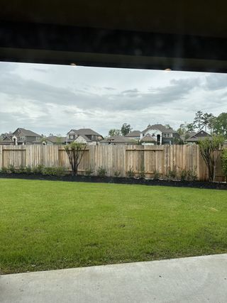Model Home Lush green backyard with privacy fence view in Barton Creek Ranch by Long Lake Ltd. (Conroe, TX).