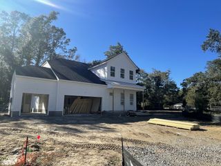 Street view A modern white home under construction in Fiddler Cove by DRB Homes, Mount Pleasant, SC.