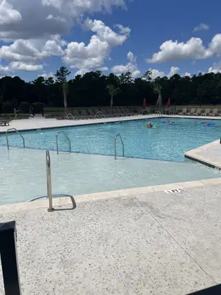Community Amenities A refreshing community pool under a bright blue sky in Hewing Farms by Mungo Homes (Summerville, SC).