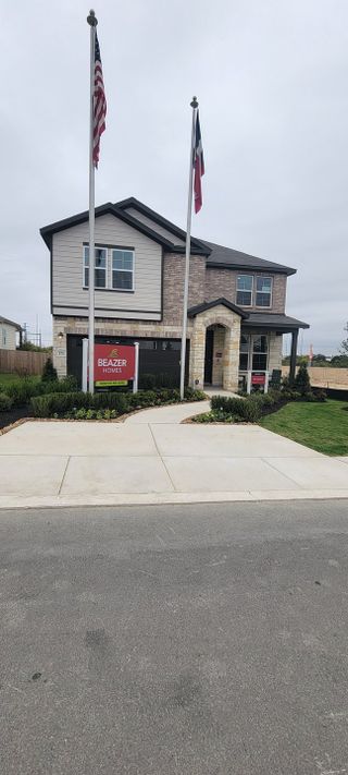 Street view A charming modern home with a blend of stone and siding in Hunter's Ranch by Beazer Homes (San Antonio, TX).