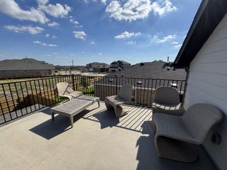 Model Home A spacious rooftop terrace with cozy seating, perfect for outdoor relaxation and scenic views.
