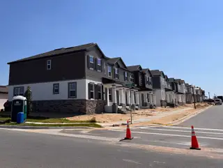 Modern townhomes with elegant facades under construction in Encore at Ovation by M/I Homes (Winter Garden, FL).