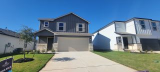A modern two-story home with stone accents and tidy landscaping in Mesa Vista by Century Communities (Von Ormy, TX).